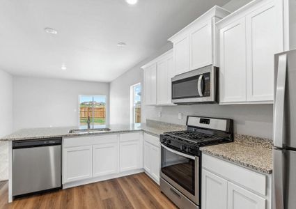 The kitchen of the Arapaho plan has beautiful granite countertops.