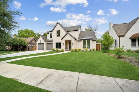 View of front of property with a garage and a front yard