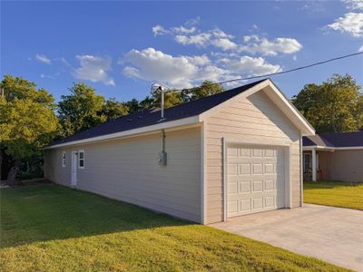 Garage featuring a yard