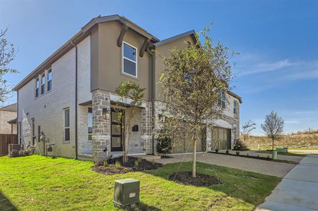 View of front of home featuring a garage, central air condition unit, and a front lawn