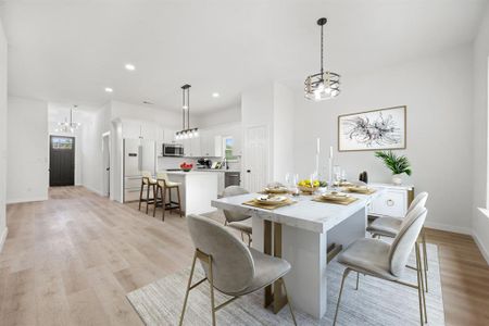 Dining room featuring light hardwood / wood-style flooring and a chandelier