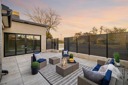 Patio terrace at dusk featuring an outdoor hangout area