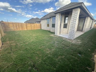 Backyard with covered patio.