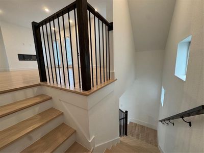 Stairs featuring baseboards and wood finished floors