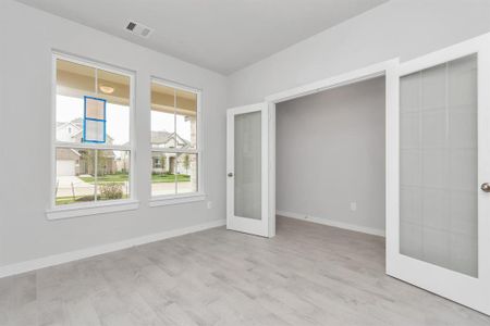 Inviting home office, featuring premium tile that adds a touch of freshness and comfort to the workspace. Natural lighting pouring through the window creates an inspiring environment for productivity and focus. Sample photo of completed home with similar floor plan. As-built interior colors and selections may vary.