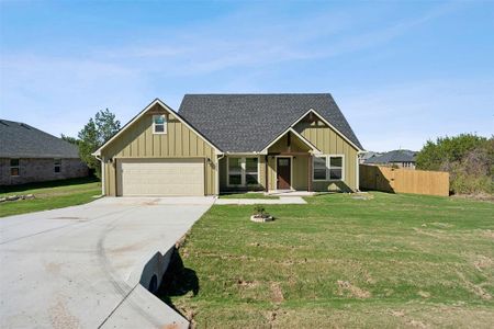 View of front of home with a front lawn and a garage