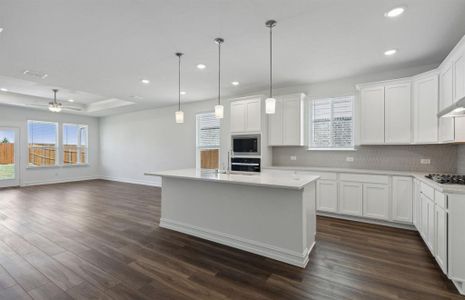 Airy kitchen with oversized island *real home pictured