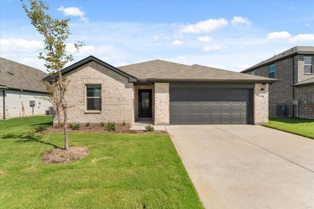 View of front of property with a front yard, central air condition unit, and a garage