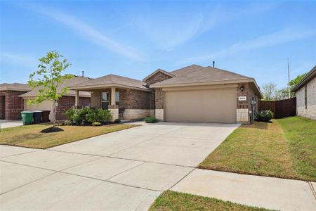 View of front facade with wood fence, driveway, a front lawn, brick, and a garage View of front facade with wood fence, driveway, a front lawn, brick, and a garage