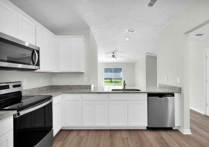 The kitchen overlooks the spacious living area.