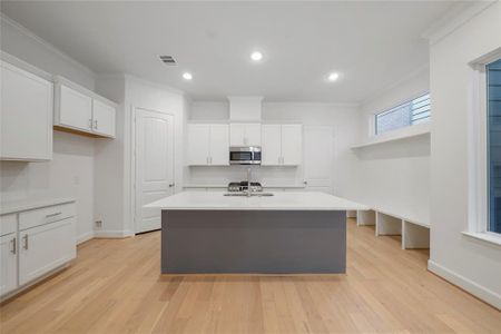 The Chesapeake Kitchen! Featuring quartz countertops, Benedettini custom cabinets, including a pull-out trash can for added convivence and Moen plumbing fixtures. (Sample photos of a completed Chesapeake floor plan. The image may feature alternative selections and/or upgrades.)