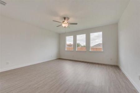 Unfurnished room with light wood-type flooring and ceiling fan