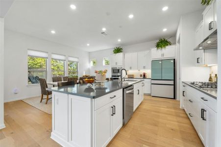 The chic and modern island kitchen opens seamlessly to the living room while still providing a nice separation of spaces.