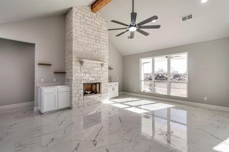 Unfurnished living room with visible vents, baseboards, and ceiling fan