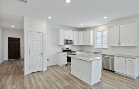 Spacious kitchen with oversized island *real home pictured