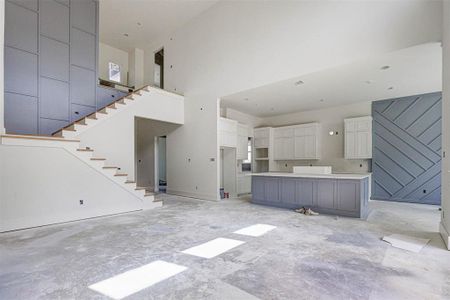 Unfurnished living room with a high ceiling