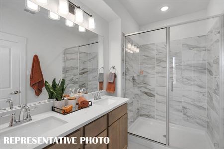 Bathroom featuring vanity and an enclosed shower