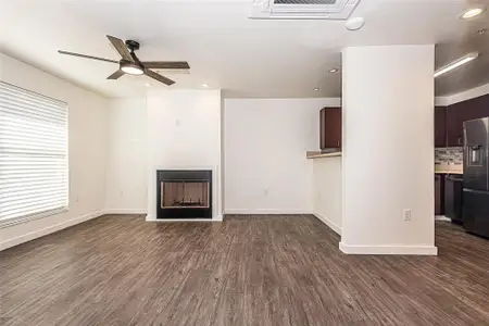 living room featuring luxury vinyl wood-style flooring, ceiling fan, and a healthy amount of sunlight