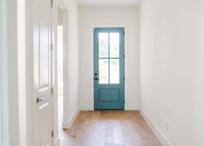 Doorway to outside featuring light hardwood / wood-style floors and plenty of natural light