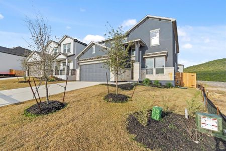 View of front of home featuring a garage and a front yard