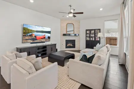 Living area featuring recessed lighting, a stone fireplace, wood finished floors, and ceiling fan