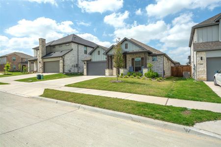 View of front facade with a garage and a front lawn