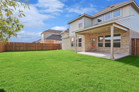 Back of house featuring a patio and a lawn