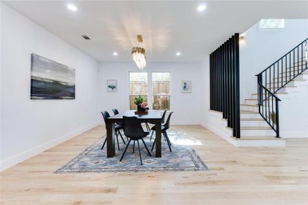 Dining area with an inviting chandelier and light hardwood / wood-style flooring