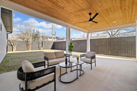 View of patio featuring ceiling fan and an outdoor living space