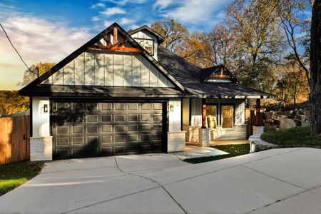 View of front facade with covered porch and a garage