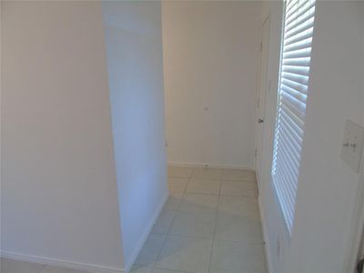 Corridor with light tile patterned flooring