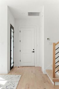 Entrance foyer featuring light wood-type flooring