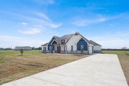 View of front of house featuring a front yard and a garage