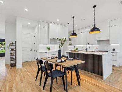 Dining space featuring sink and light wood-type flooring