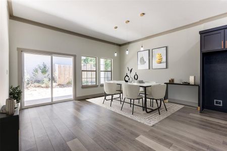 Dining room with crown molding and dark wood-type flooring