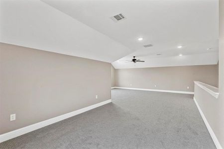 Bonus room with ceiling fan, carpet flooring, and lofted ceiling