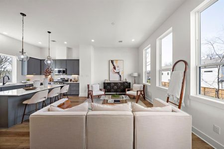 Bright and inviting living space featuring large windows, an open layout, and modern finishes. Perfect for entertaining and relaxation.