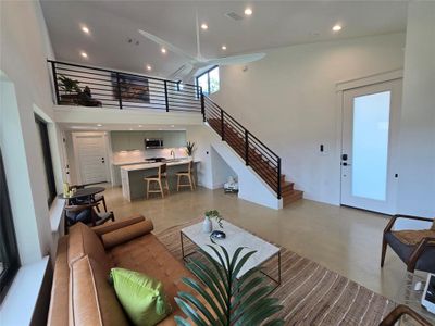 Huge open living room with lots of windows and an open loft looking out to the living space.