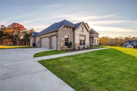 French provincial home featuring a yard and central air condition unit