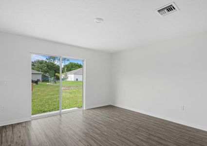 The family room is spacious and has a sliding glass door leading to the backyard