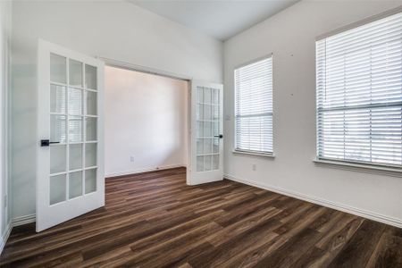 Unfurnished room featuring dark wood-type flooring and french doors