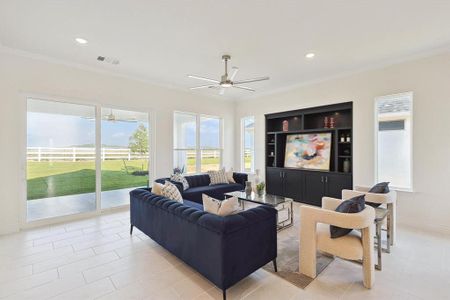 Living room with crown molding, ceiling fan, and light tile floors