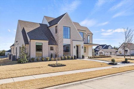 Lavish landscaping adorns amenity packed custom home