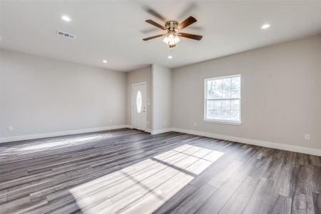 Similar home: Living room with wood-style floors and ceiling fan