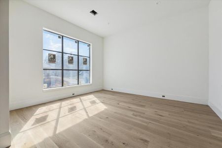 Adjacent to the foyer, the dining room will showcase a brass and glass chandelier and soaring window with view of the front yard. The home offers white oak 7" engineered wood floors throughout.