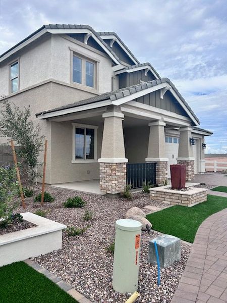 A modern two-story home with stone accents and tidy landscaping in Ridgeline at Acclaim by Fulton Homes (Avondale, AZ).