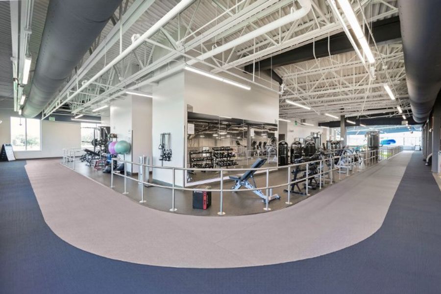A large empty room with a few chairs and a few tables. A large empty room with a few chairs and a few tables.