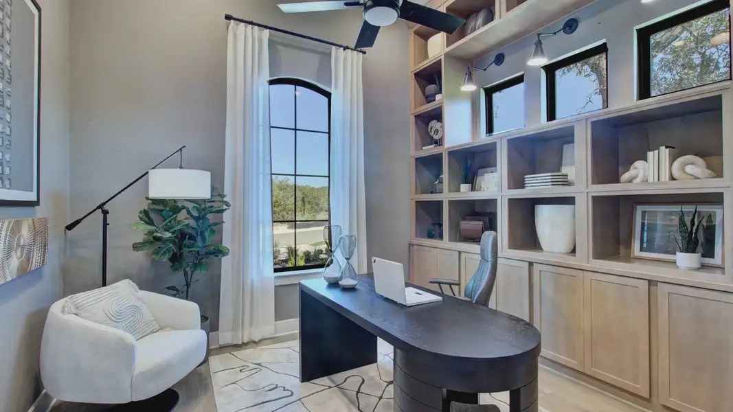 Custom wood shelving and expansive windows elevate this San Antonio office's refined design in Verandas at the Rim.