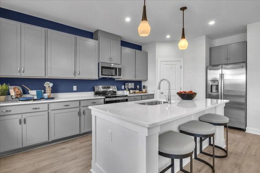 Spacious kitchen with a large island and abundant cabinetry, offering practical storage and room to gather with ease