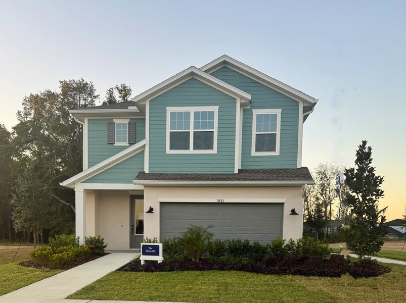 Front exterior of a home in the Persimmon Place – Garden Series community, located in Wesley Chapel, FL (Image 4).
